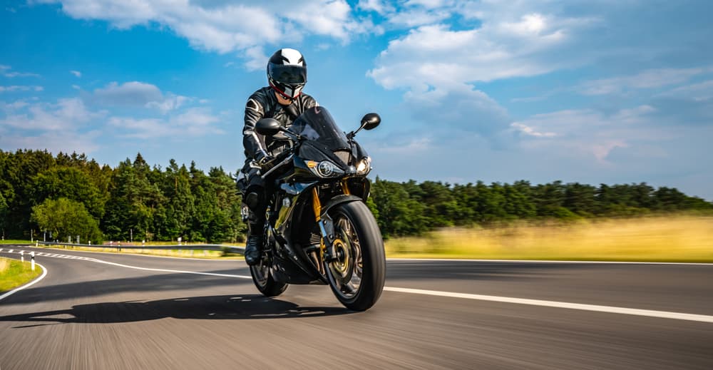 Motorcycle cruising down an open road, enjoying the ride on a scenic journey.