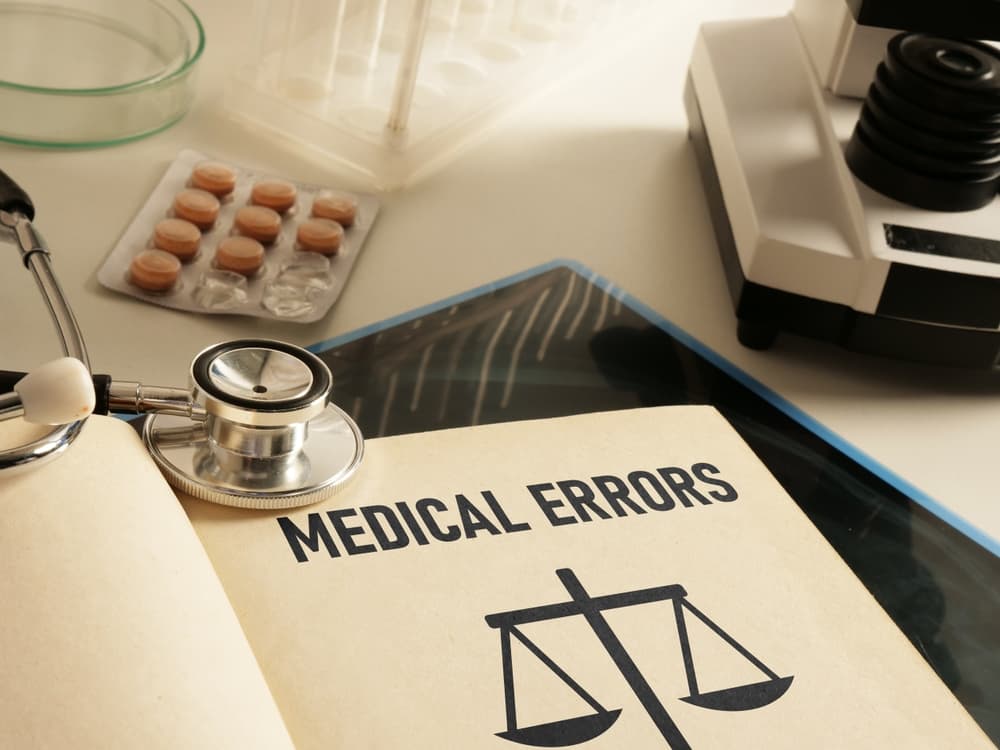 Medical errors are illustrated with text from the book and an image of a stethoscope.